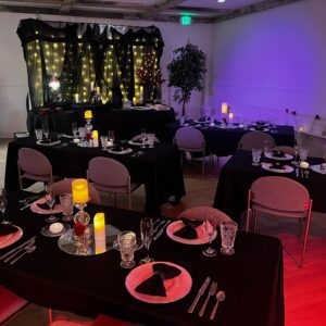 Holiday House Decorated indoor event area with tables and chairs